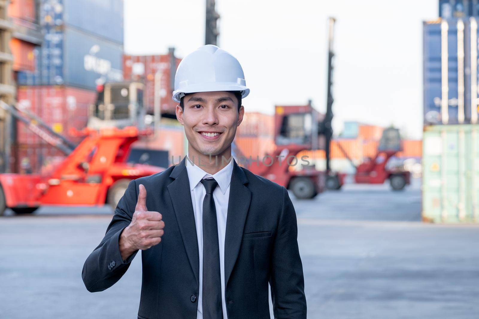 Portrait of engineer worker of factory technician with Chinese style man stand with thumbs up and smile in workplace area. Concept of good support best successful for industrial business.