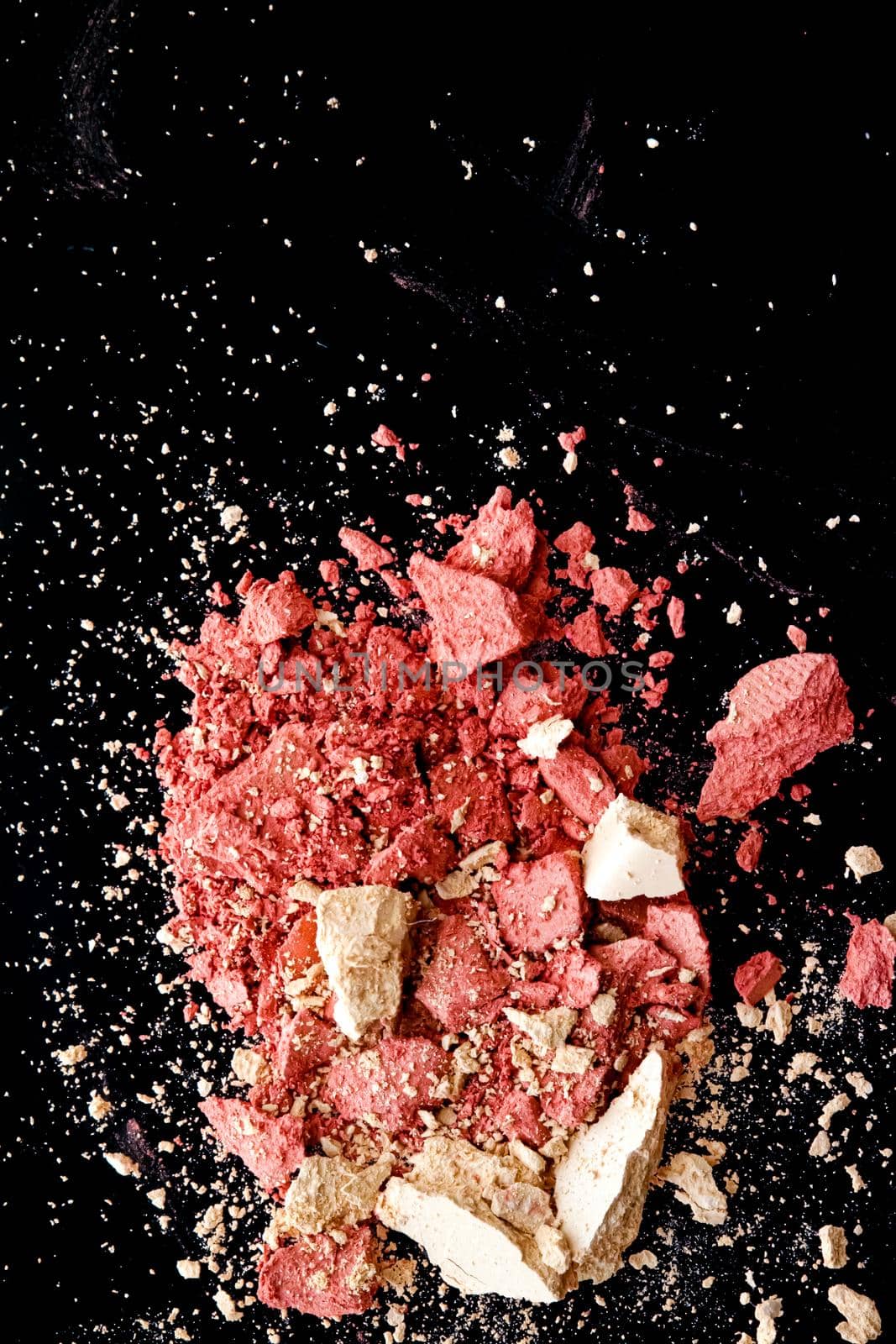 Crushed cosmetics, mineral organic eyeshadow, blush and cosmetic powder isolated on black background, makeup and beauty banner, flatlay design.