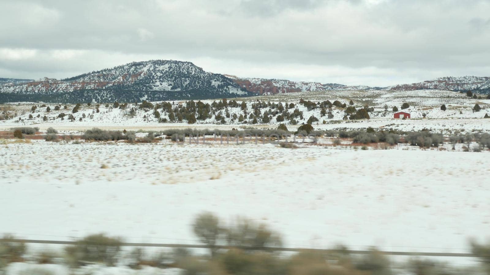 Road trip in USA from Zion to Bryce Canyon, driving auto in Utah. Hitchhiking traveling in America, Route 89 to Dixie Forest. Winter local journey, calm atmosphere and snow mountains. View from car.