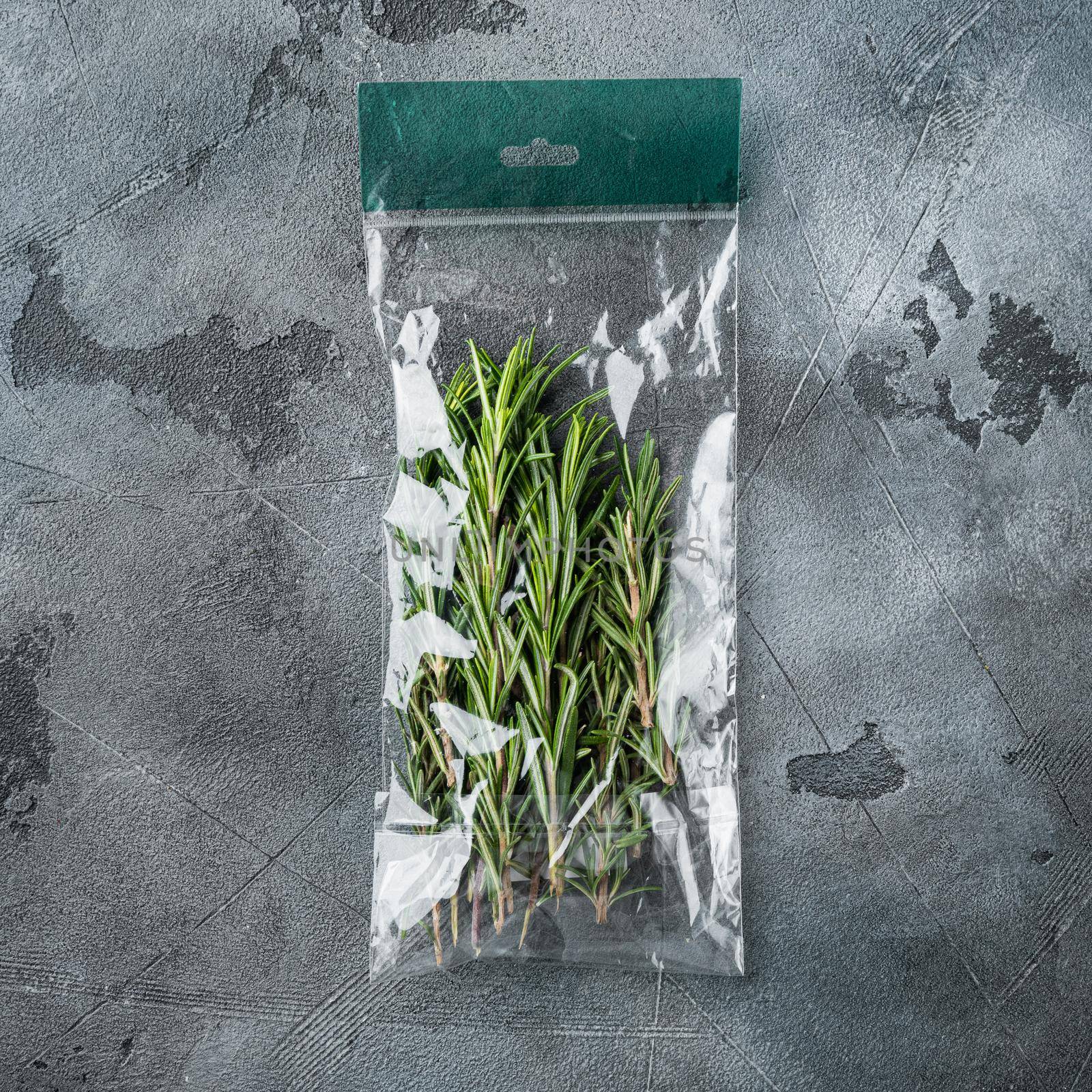 Rosemary in plastic bag, on gray background, top view flat lay by Ilianesolenyi