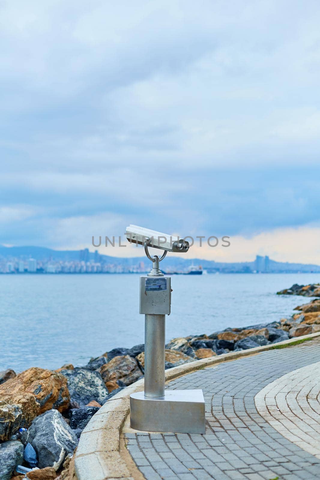 Tourist sightseeing binoculars on the promenade of Buyukada island overlooking Istanbul.