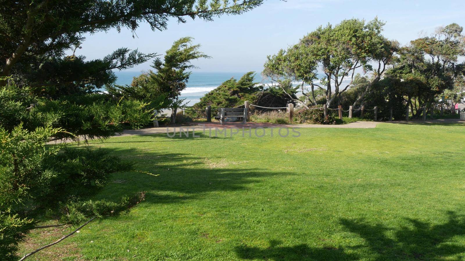 Seagrove recreation beach park in Del Mar, California USA. Seaside garden with lawn in waterfront resort. Green grass and ocean coast view from above. Picturesque coastline vista point on steep hill.