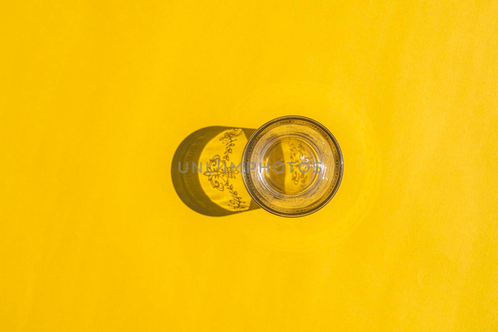 glass with a hard shadow on a colored background. High quality photo