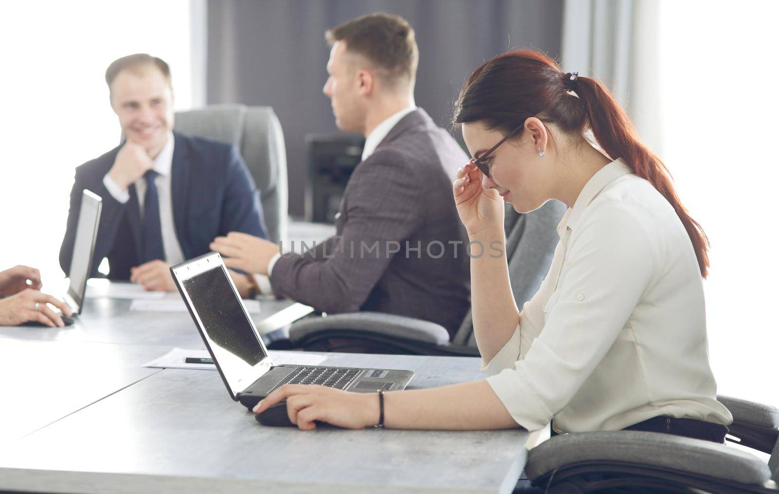 Young attractive business woman working in the office, developing her strategy. 
