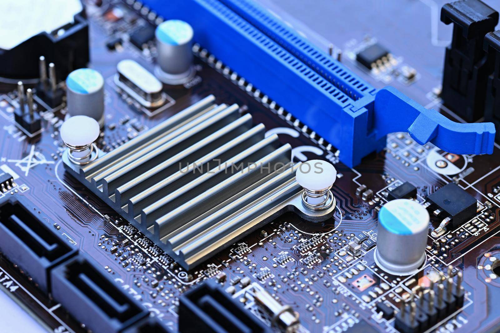 Components on board. PCB to PC. Chip, capacitor and connectors on the motherboard of a personal computer. Modern technological background. by Montypeter