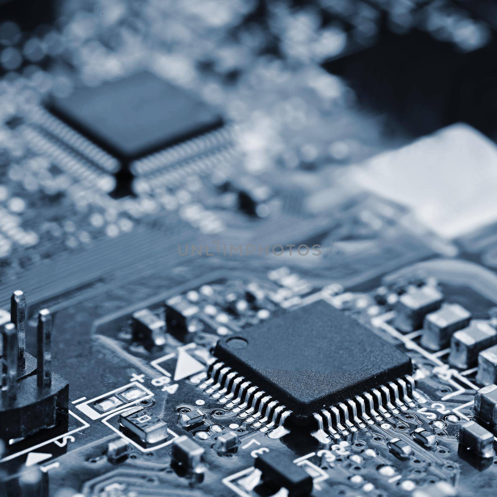 Components on board. PCB to PC. Chip, capacitor and connectors on the motherboard of a personal computer. Modern technological background. by Montypeter