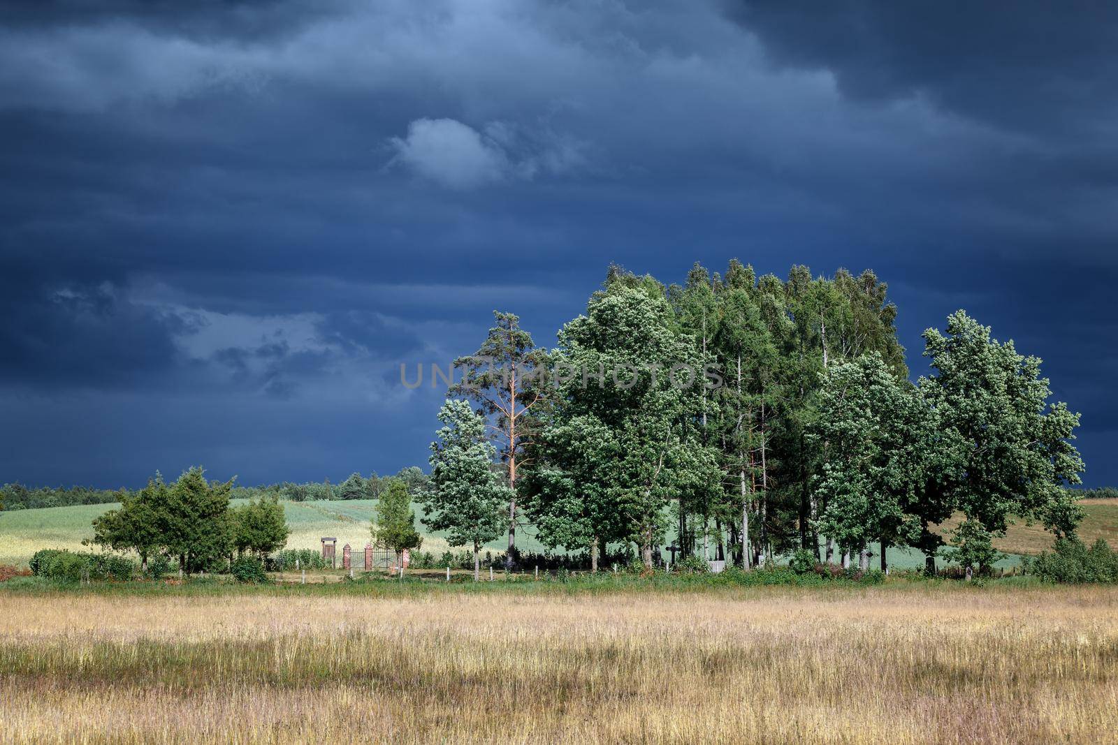 The cemetery and the gloomy sky above them by Lincikas