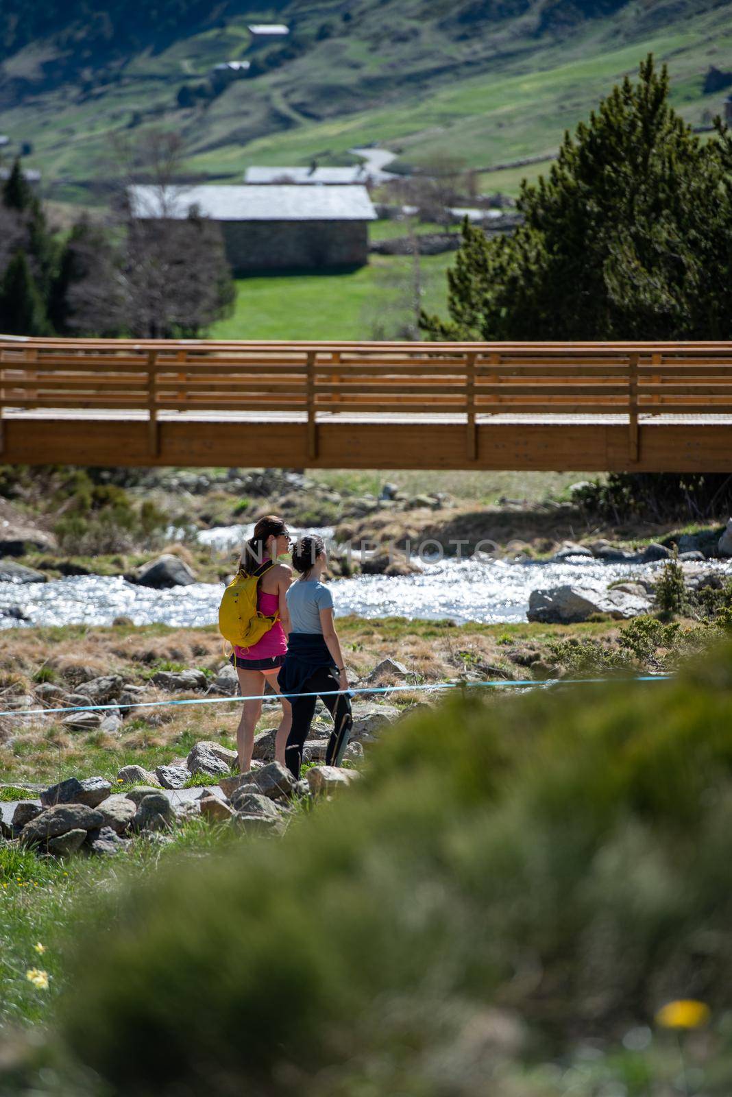 Two women trekking in the vall de incles in Andorra in spring 2021. by martinscphoto