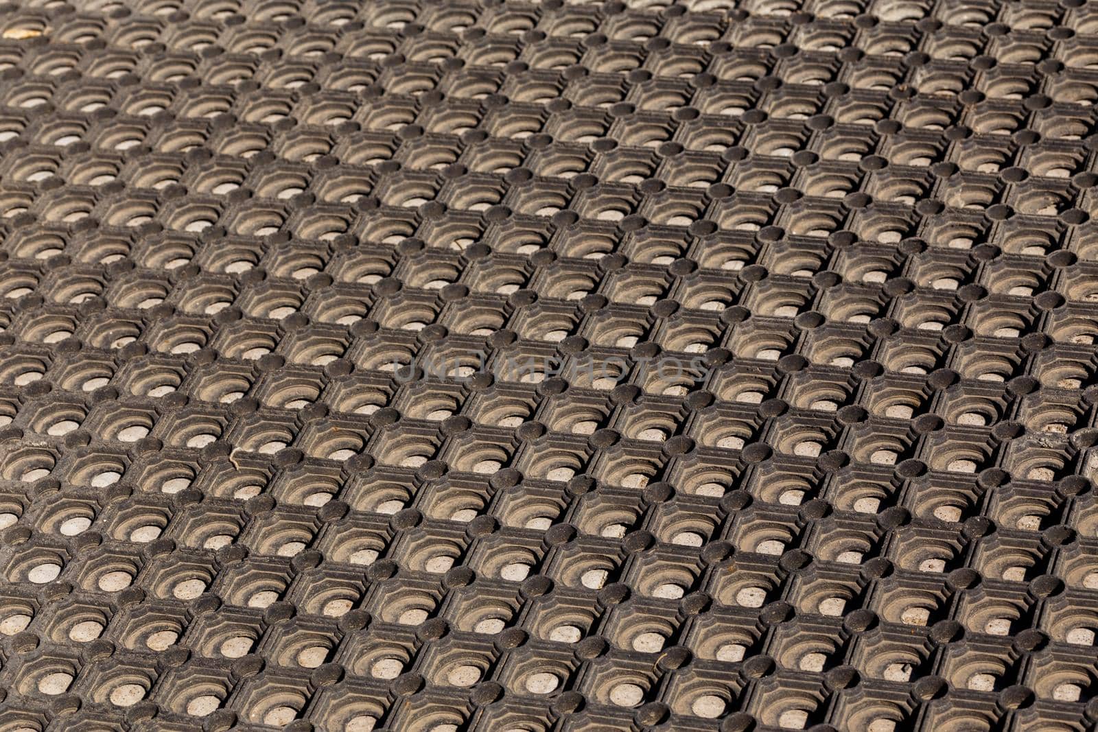 texture and background of used dusty cellular rubber floor mat - perspective view
