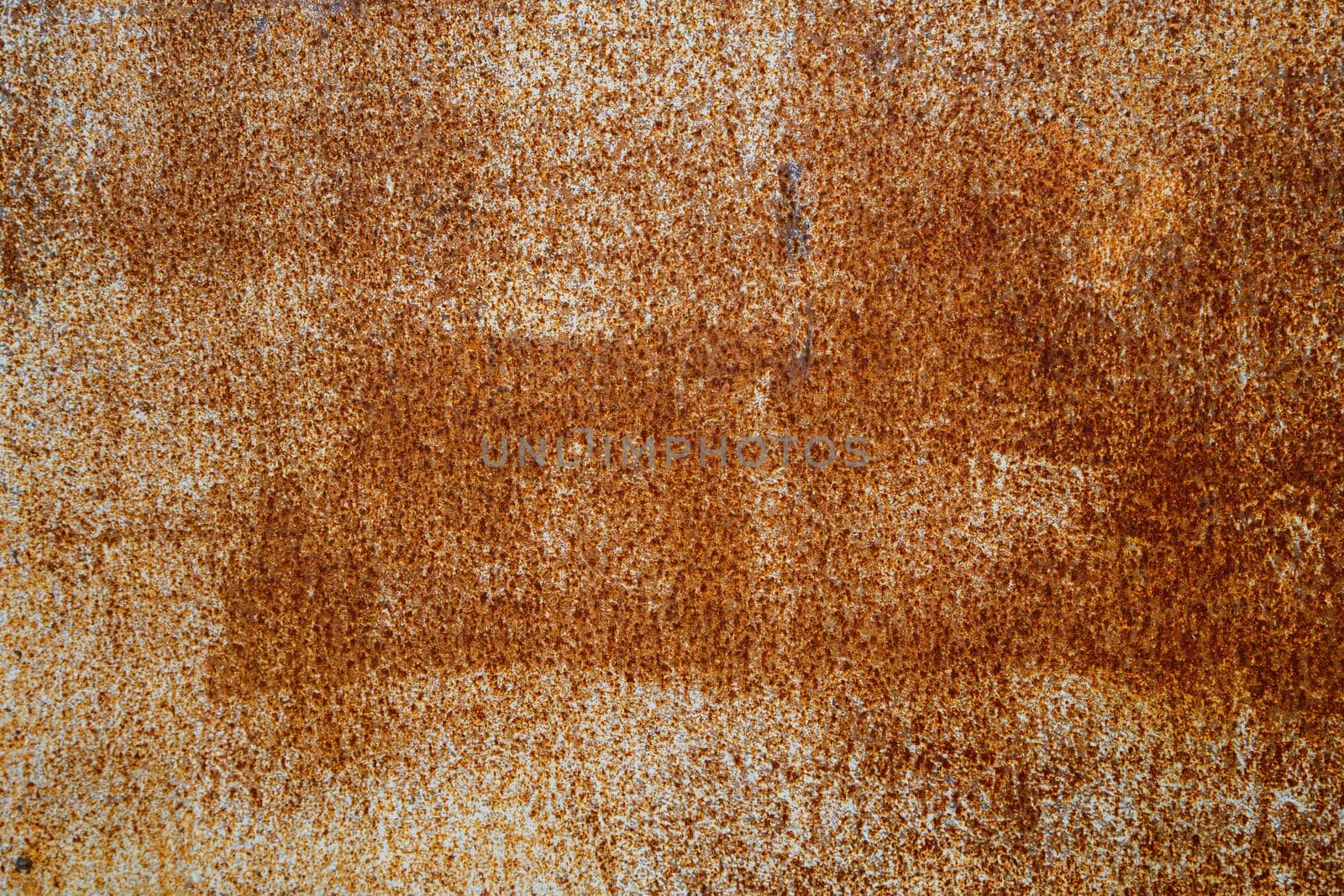 abstract background and texture of white peeling paint surface with orange rust spots.