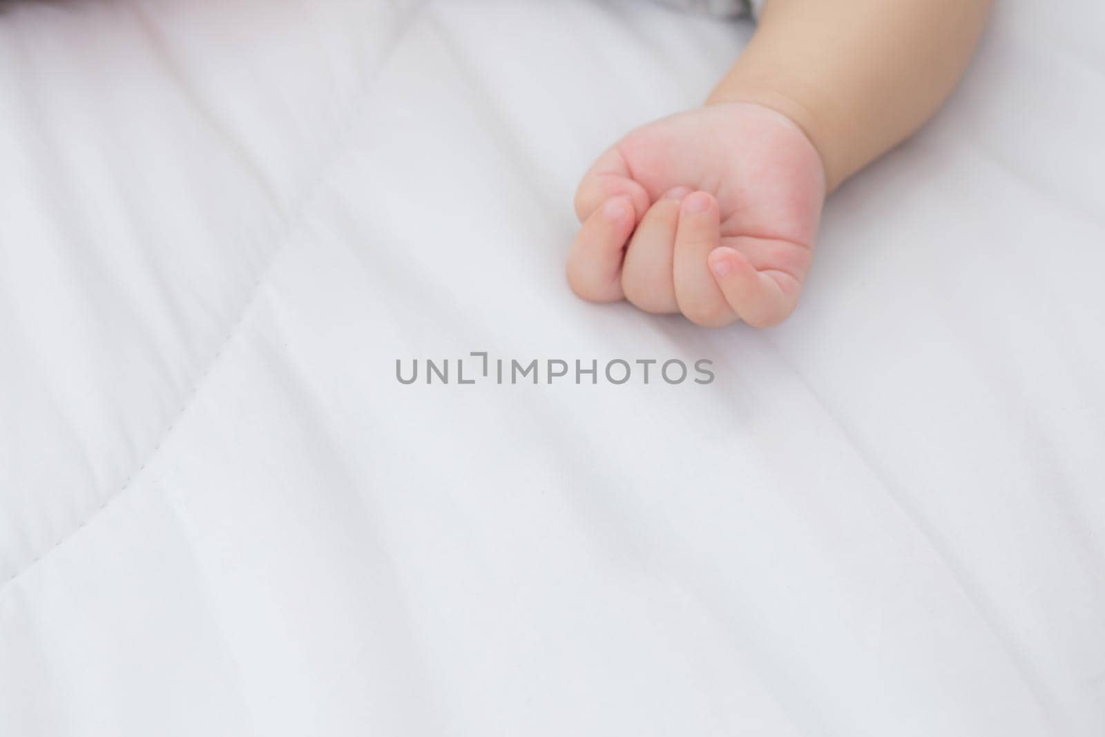 Portrait of asian little baby girl sleeping on bed in the bedroom at home, newborn napping with cozy and relax, infant innocence in bedtime, happy toddler cute, growth of child and emotion, indoors.