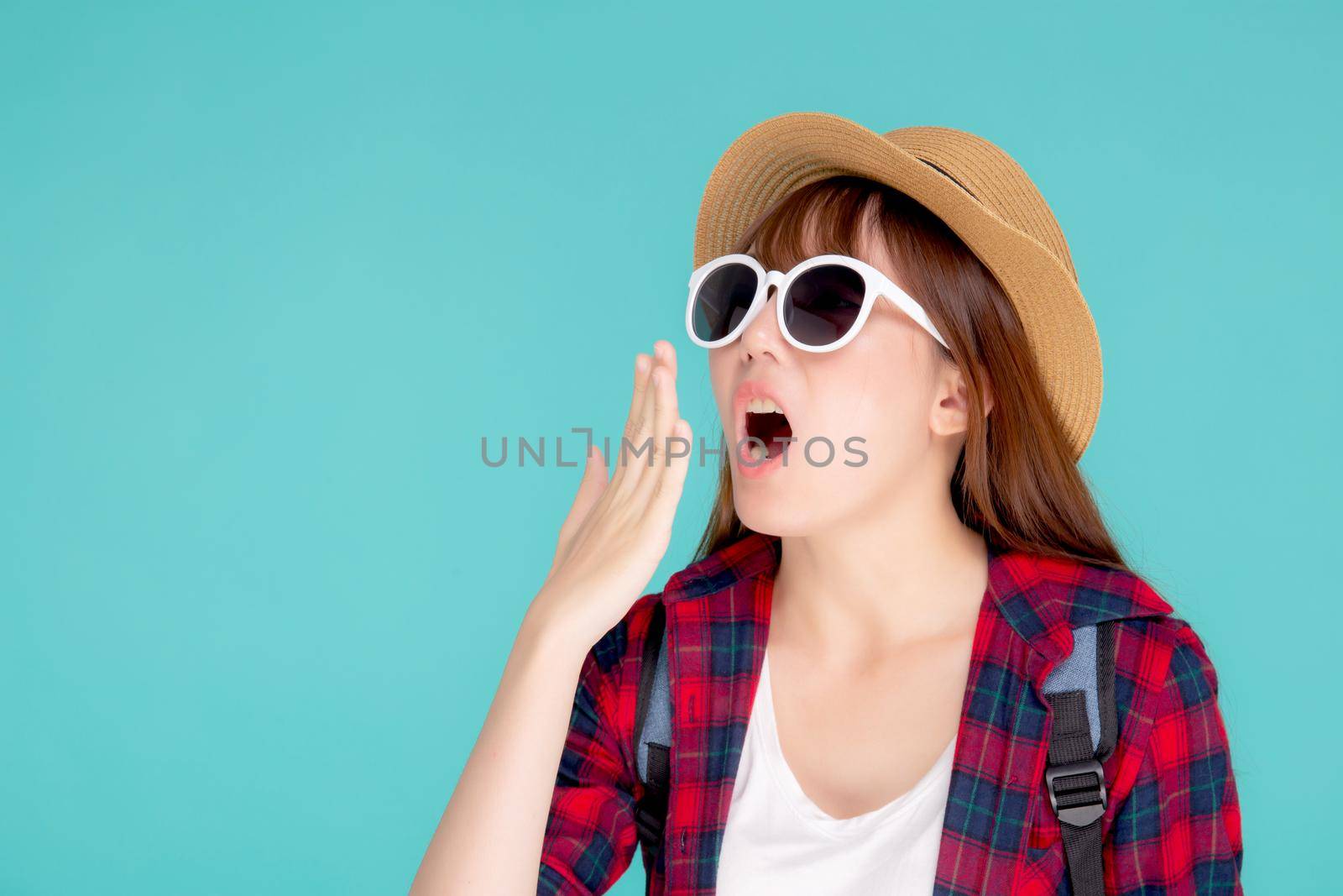 Beautiful young asian woman shouting sound loud with mouth for announce something in vacation travel with excited isolated on blue background, tourist asia girl journey in summer concept.
