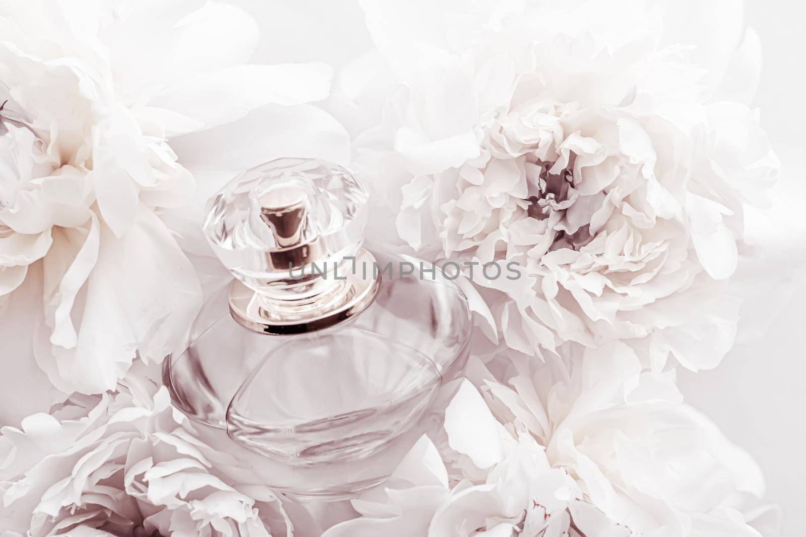 Chic fragrance bottle as luxe perfume product on background of peony flowers, parfum ad and beauty branding design