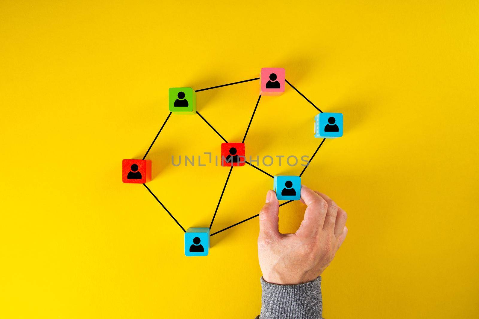 Wooden cube block print screen person icon which link connection network for organisation structure by tehcheesiong