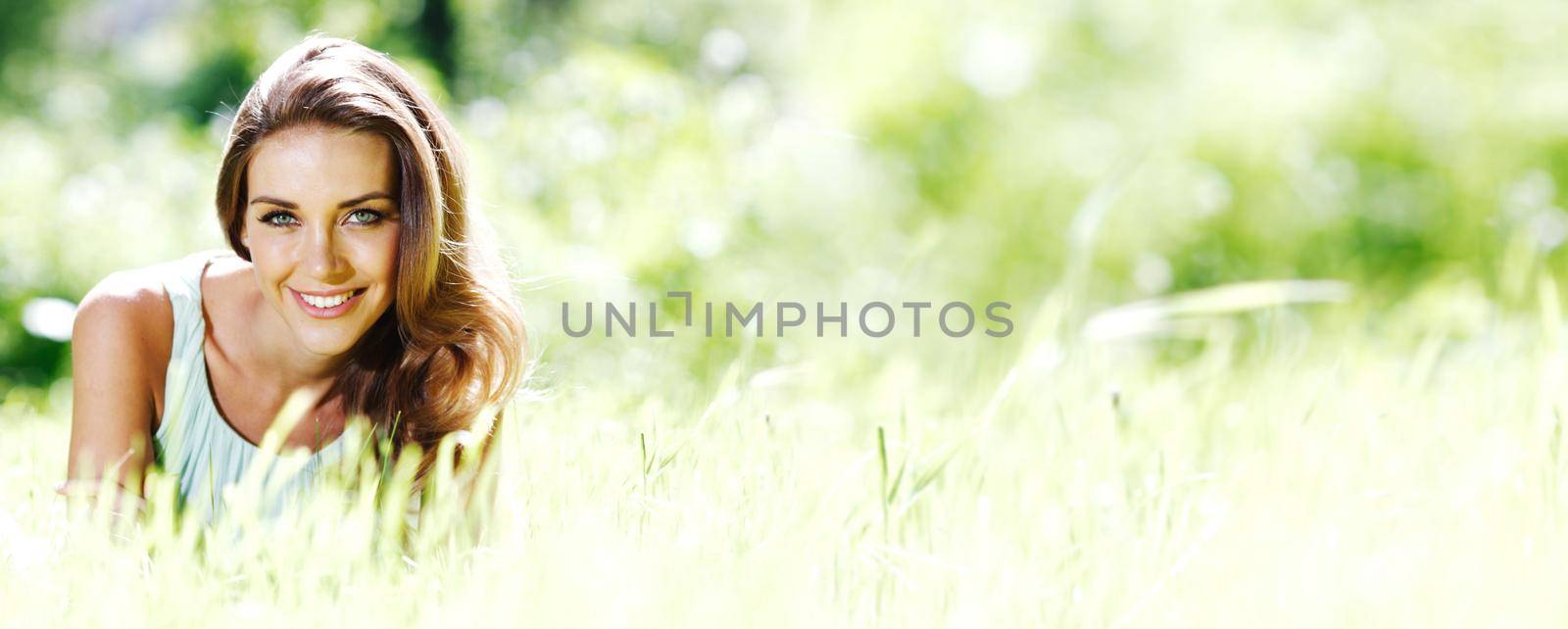 Portrait of attractive green eyes girl smiling in spring park nature background