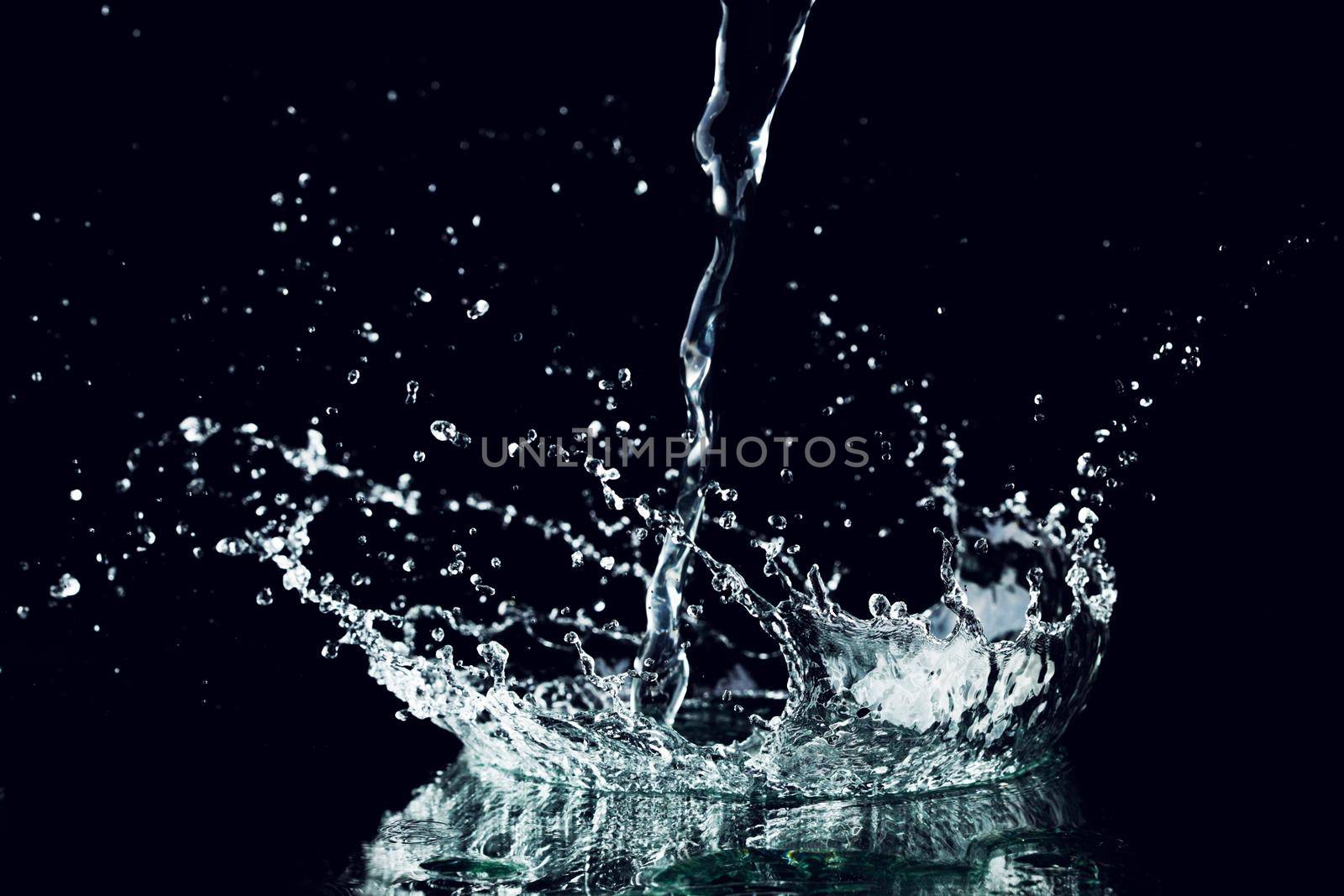 Water splash brilliant drops isolated on black background close-up