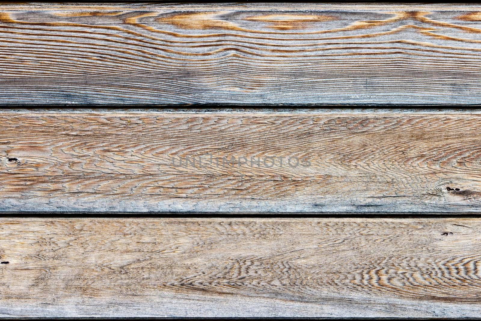 Three horizontal natural wooden panels. The panels are light brown in colour and have a silver tint.