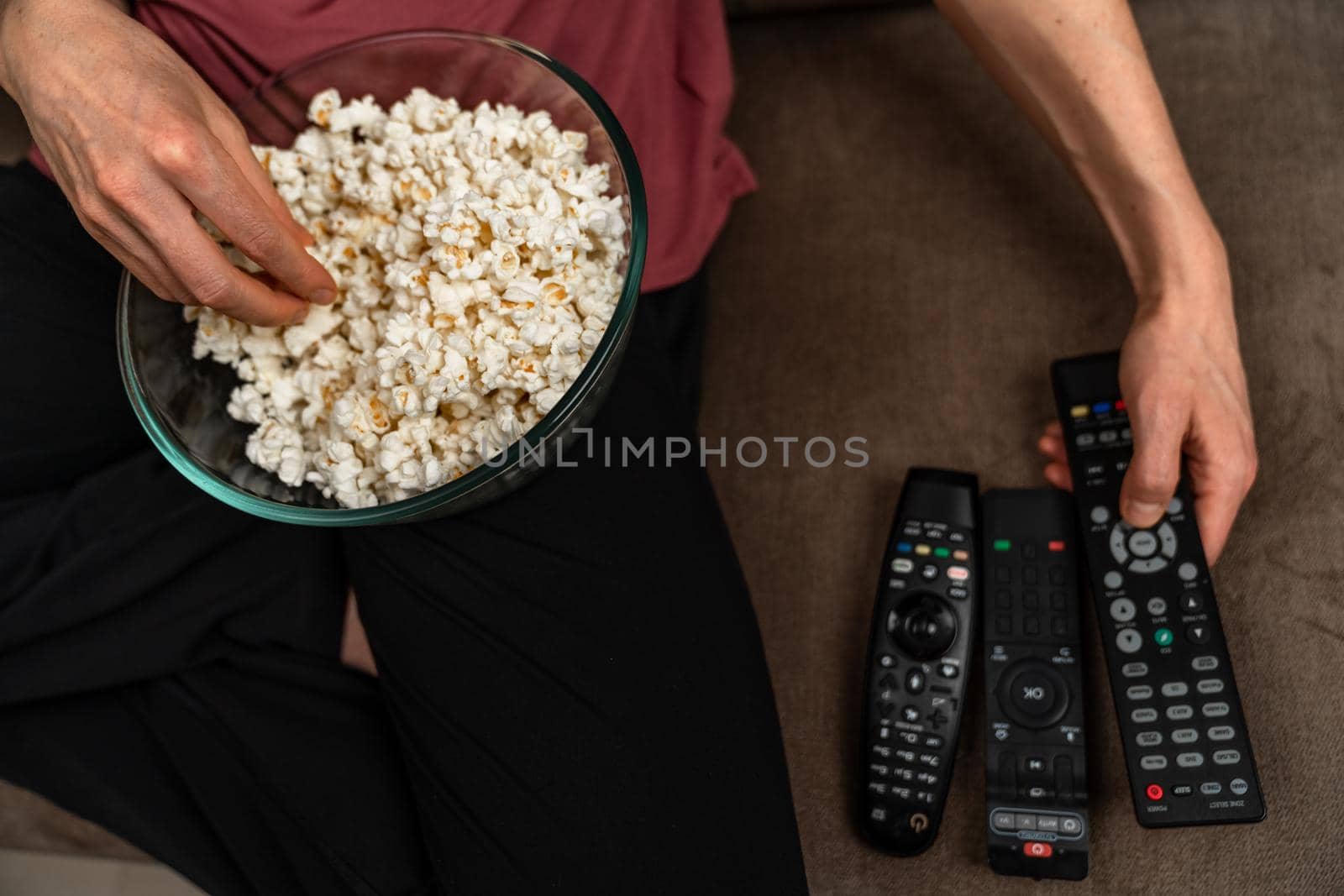 remote control and popcorn when watching a movie and broadcasting by Edophoto