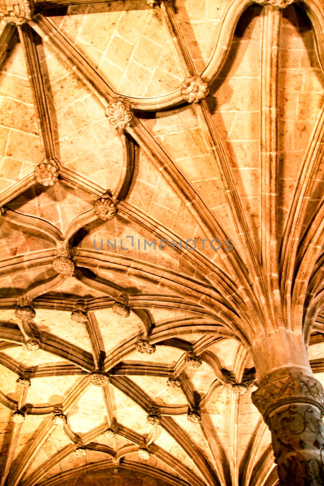 Arches and monumental columns with carved stone details of Santa Maria de Belem in Lisbon, Portugal