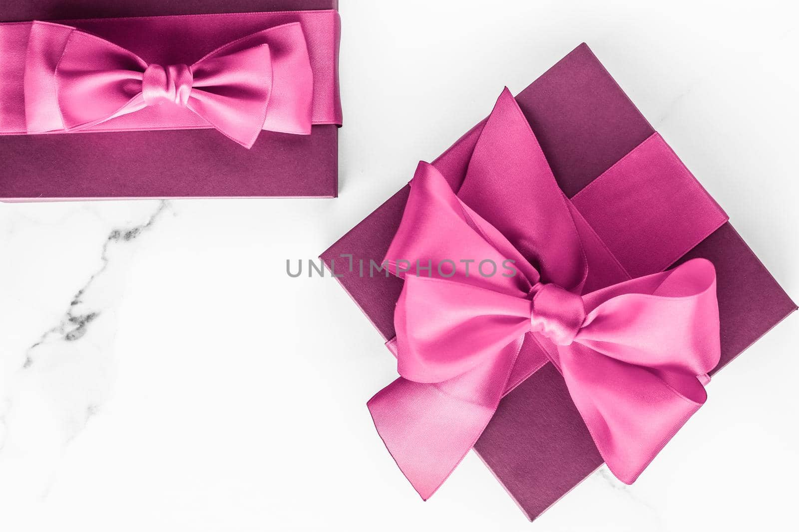 Birthday, wedding and girly branding concept - Pink gift box with silk bow on marble background, girl baby shower present and glamour fashion gift for luxury beauty brand, holiday flatlay art design