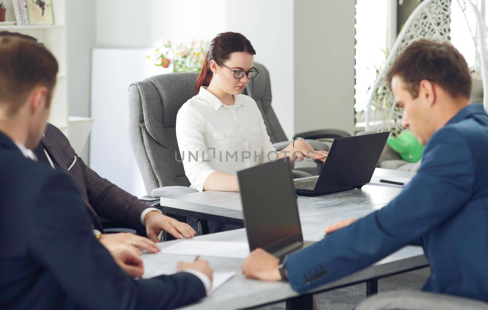 Young attractive business woman working in the office, developing her strategy by selinsmo