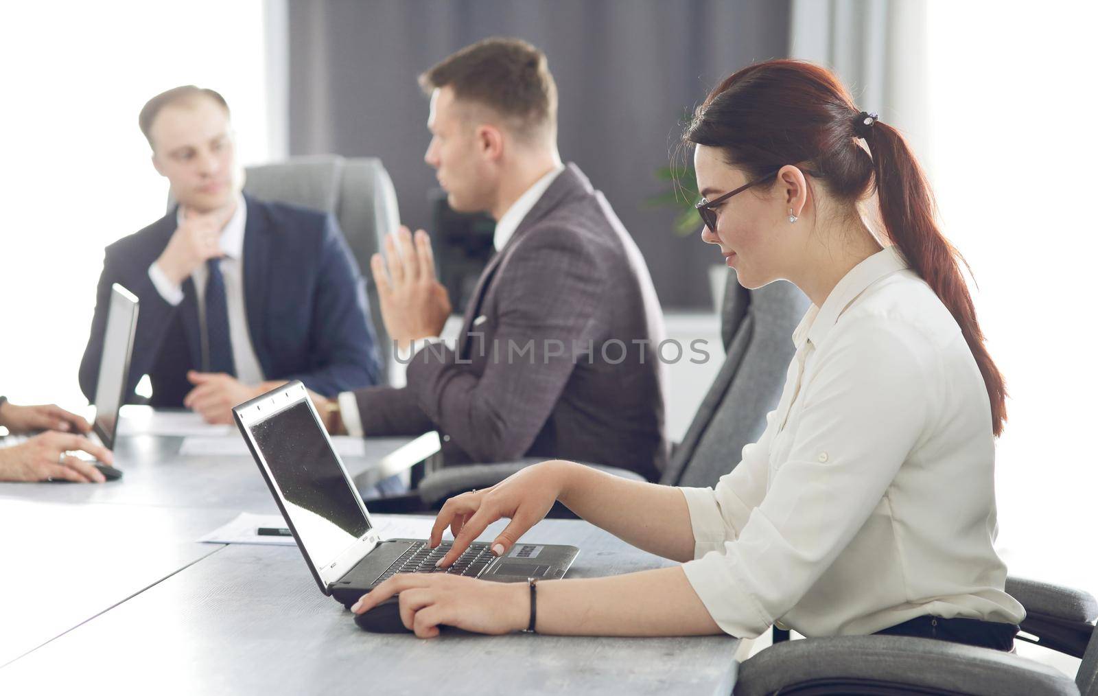 Young attractive business woman working in the office, developing her strategy. 