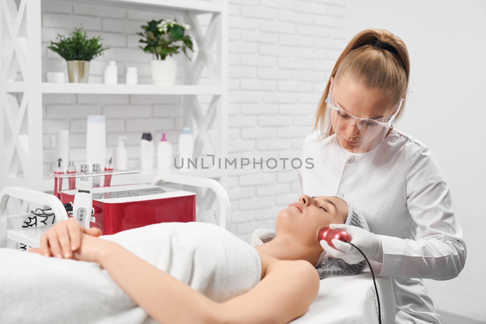 Woman doing cleaning for face in professional salon.  by SerhiiBobyk