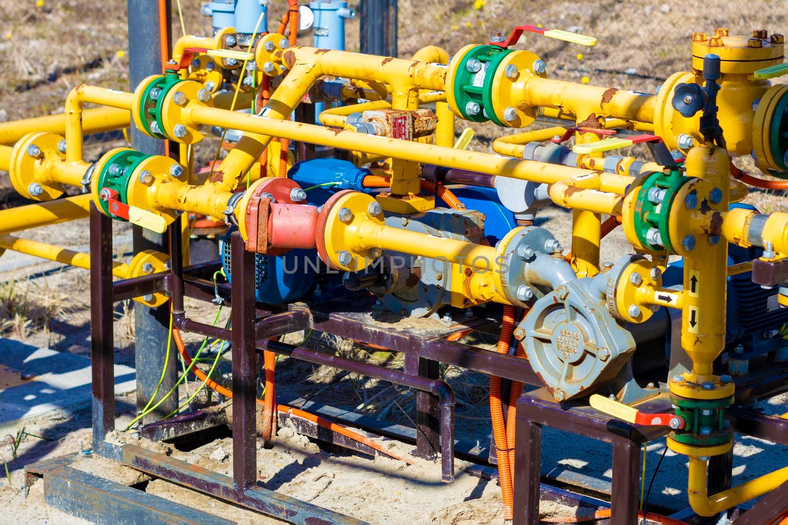 The gas distribution station of the pipes is yellow. Surgut, Russia - 16 April 2021 by Essffes