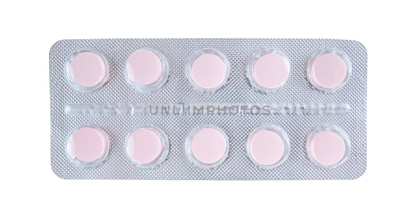 Pink tablets in blister isolated on a white background.