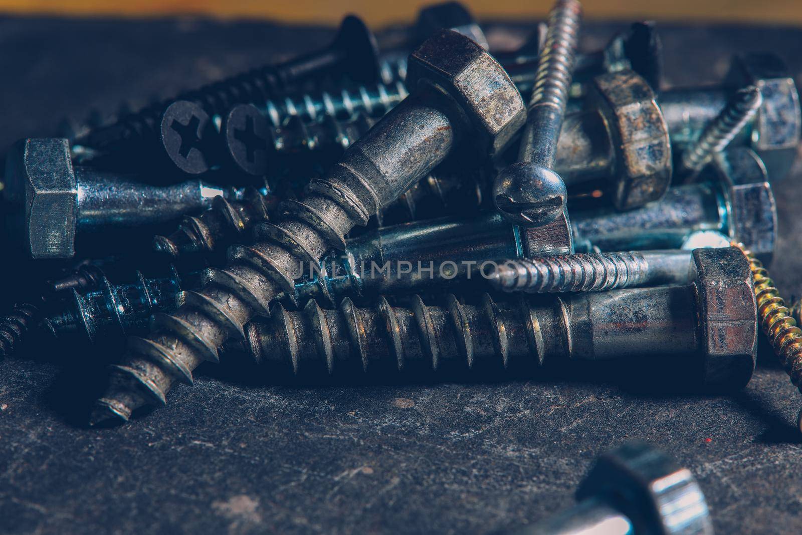 Different Kind of Screws on a table in a workshop by Weltblick