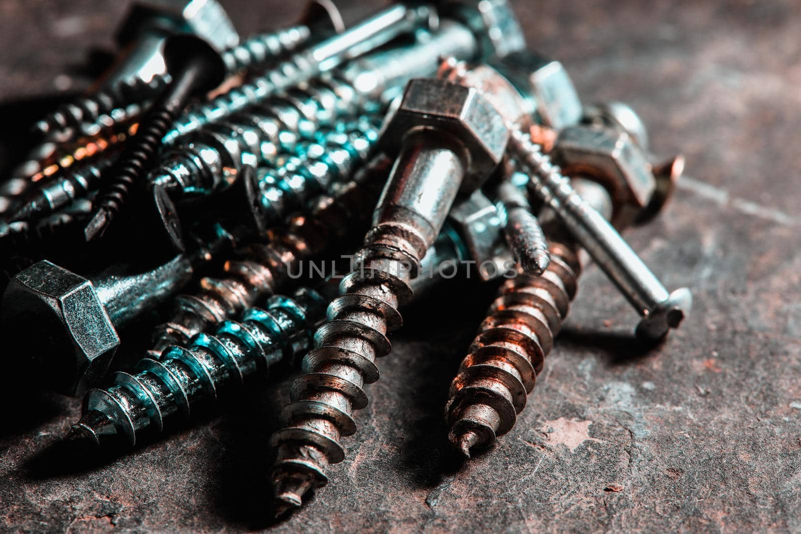 Different Kind of Screws on a table in a workshop by Weltblick