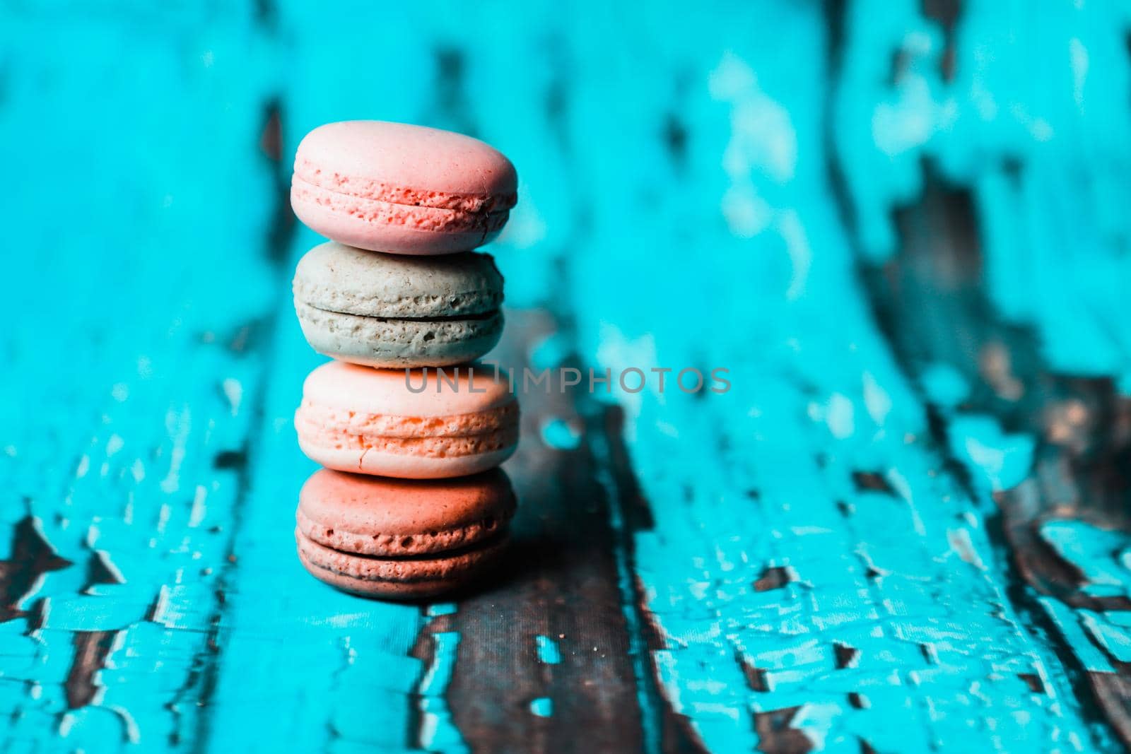 Macarons on wooden background by Weltblick