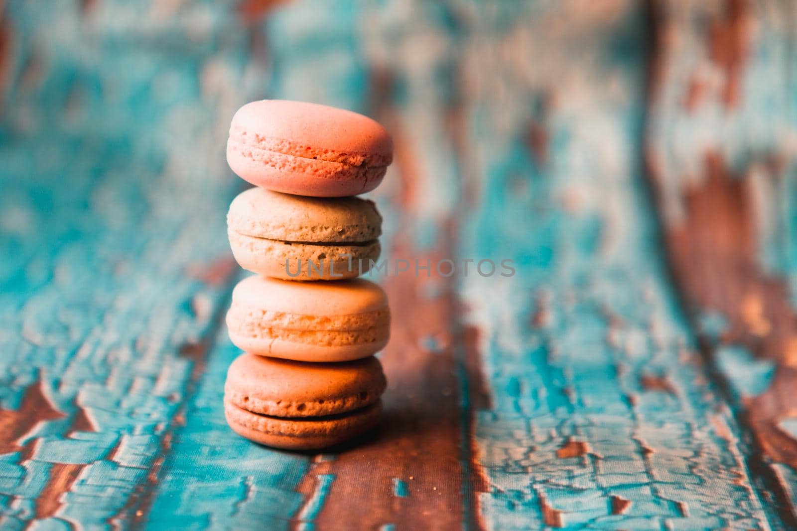 Macarons on wooden background by Weltblick