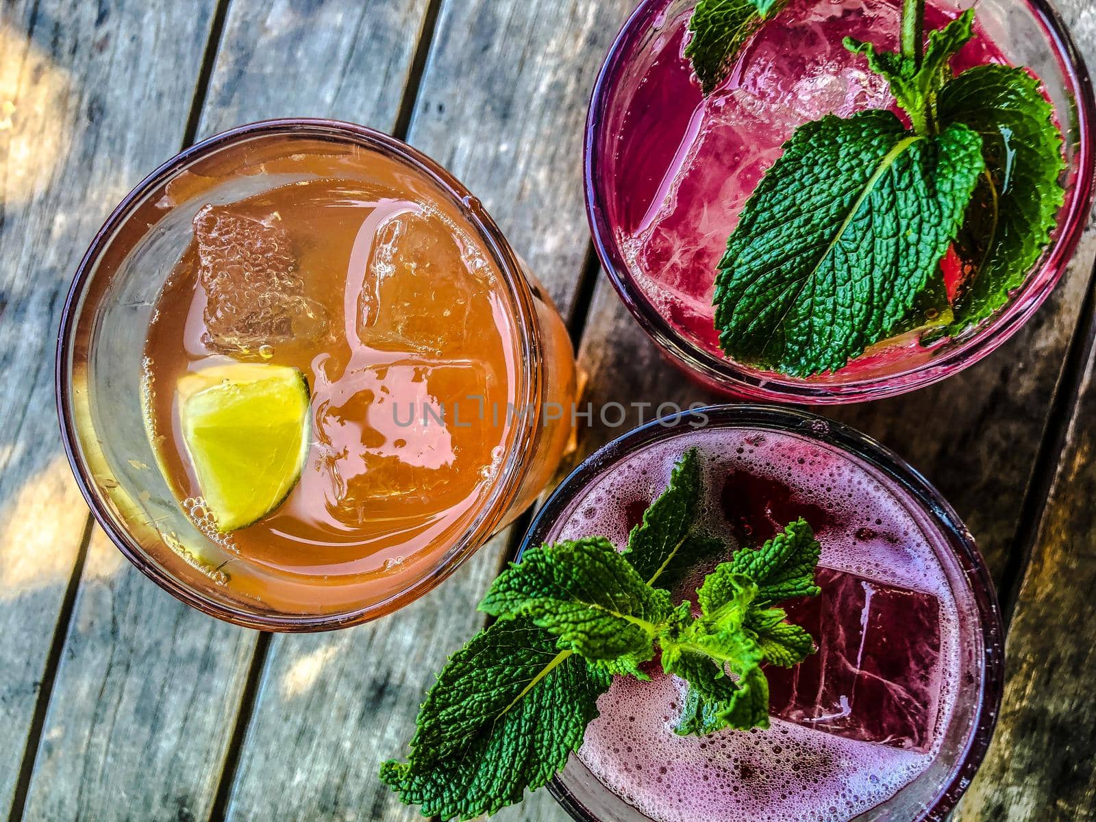 Homemade Lemonade on a wooden Table in a Bar by Weltblick