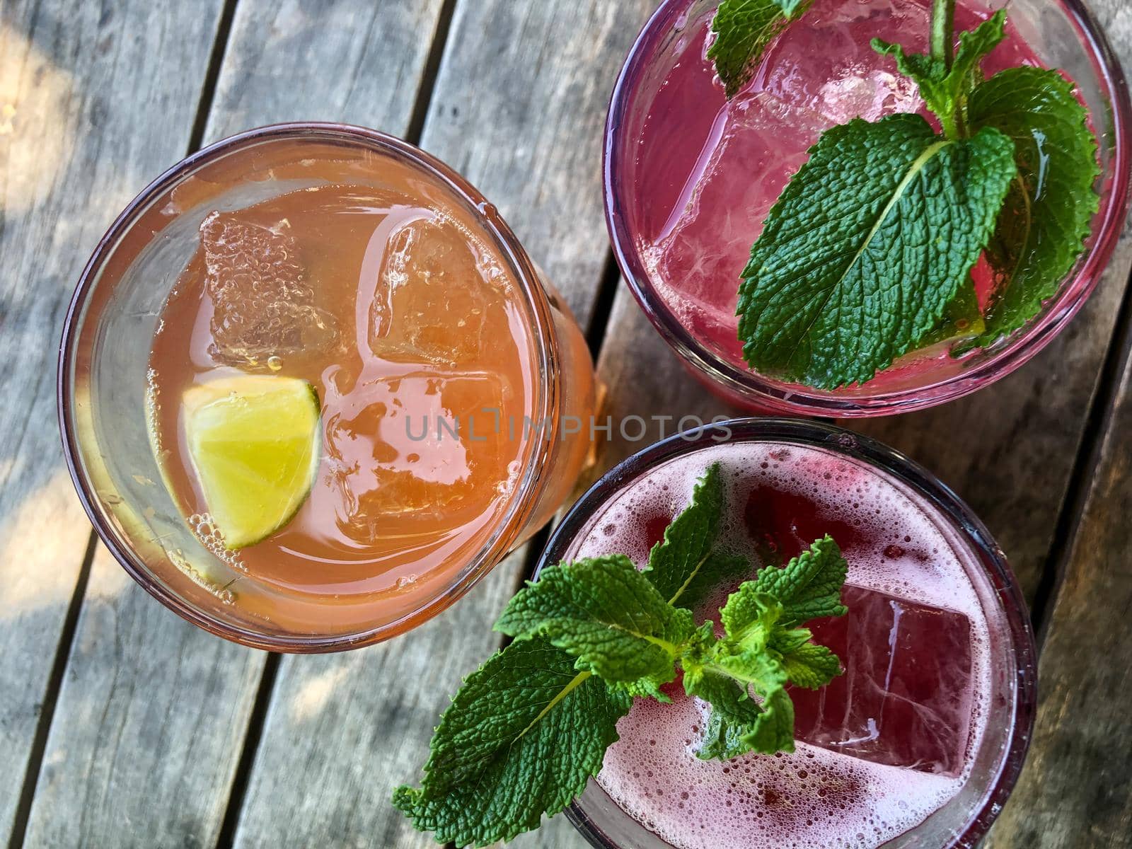 Homemade Lemonade on a wooden Table in a Bar by Weltblick