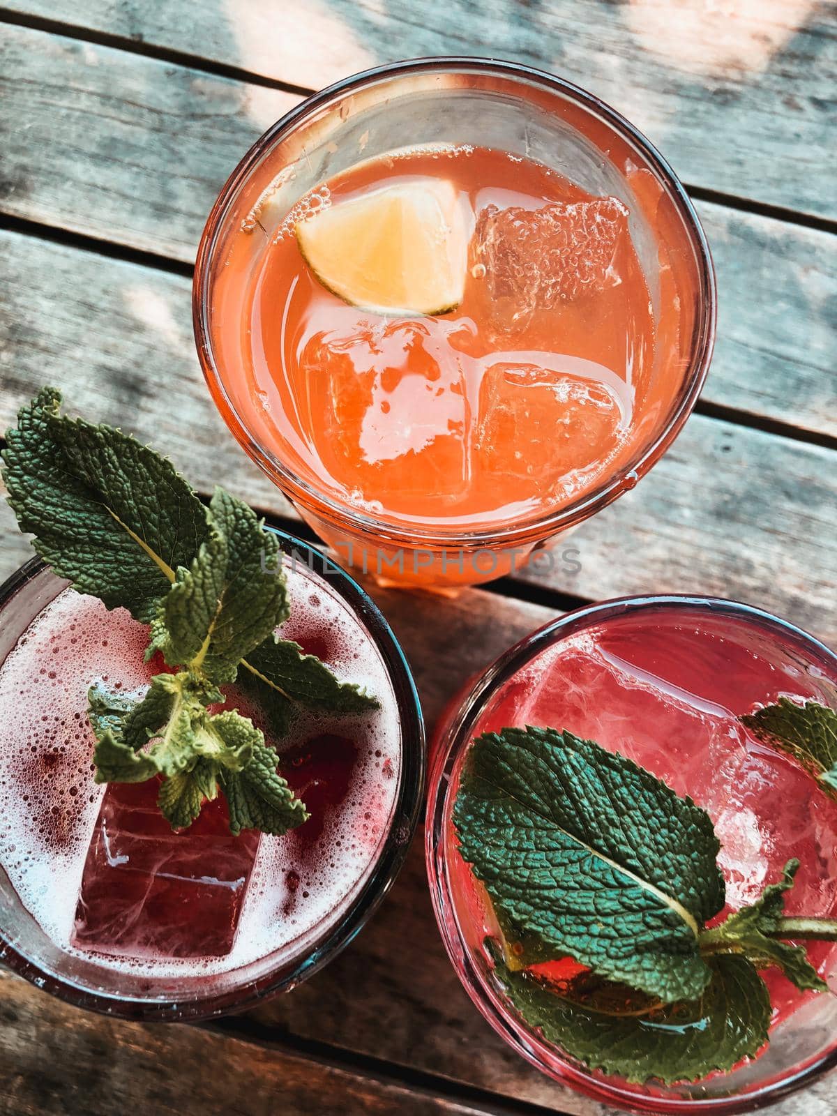 Homemade Lemonade on a wooden Table in a Bar by Weltblick