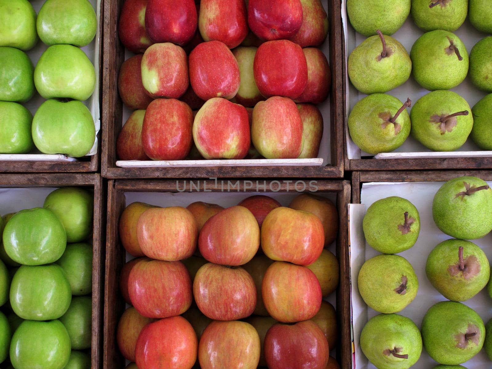 Fresh apples and pears on grocery store Background