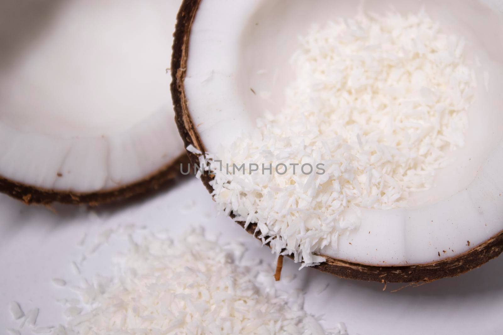 opened coconut with coconut flakes isolated on white background. tropical, nut.