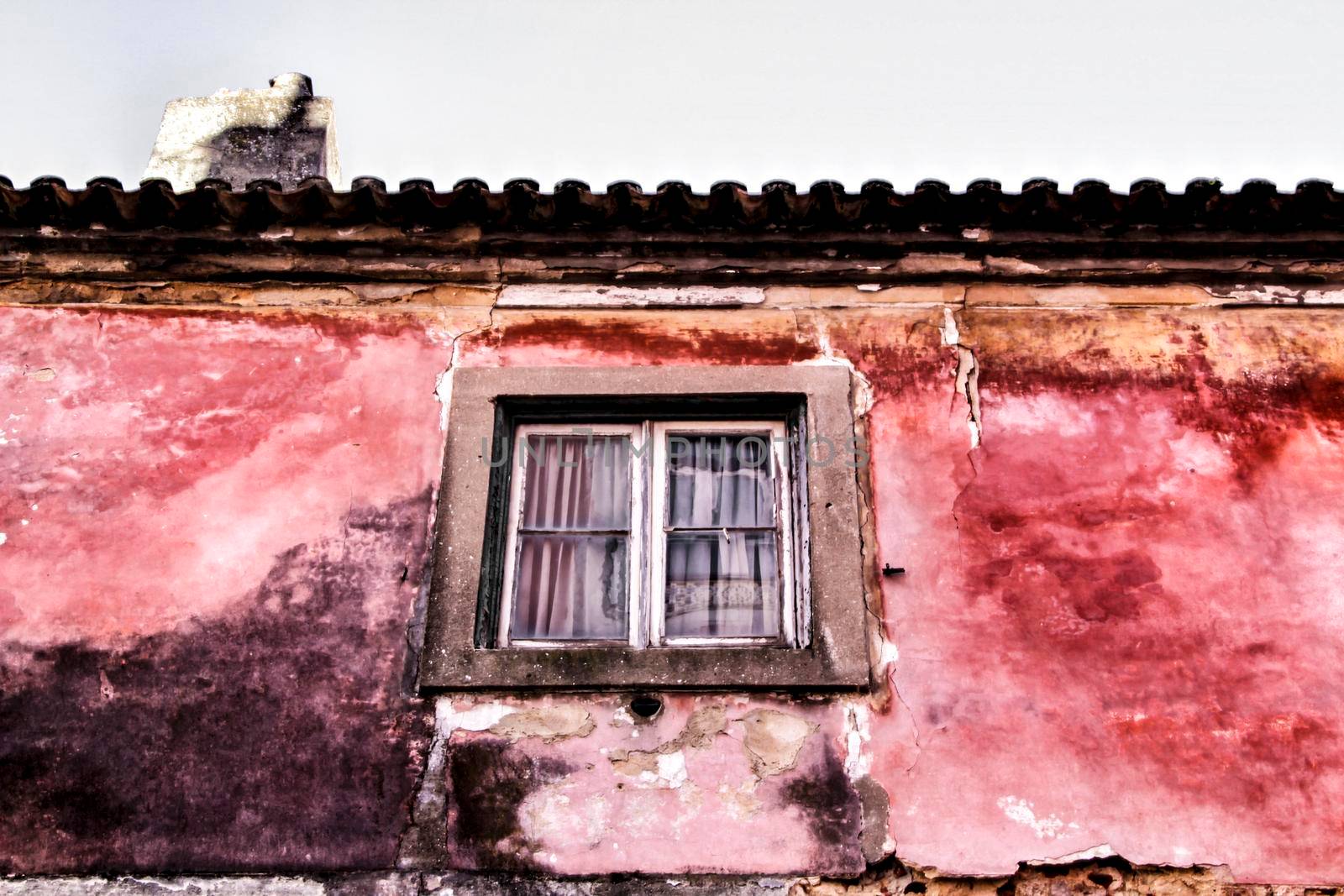 Old and colorful damaged facade in Lisbon