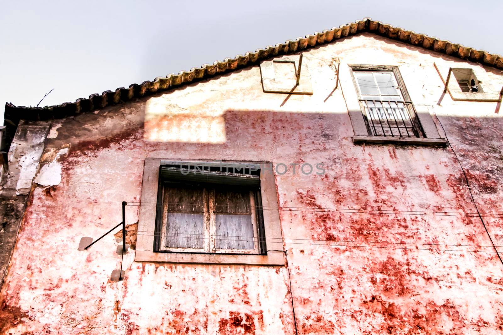 Old and colorful damaged facade in Lisbon