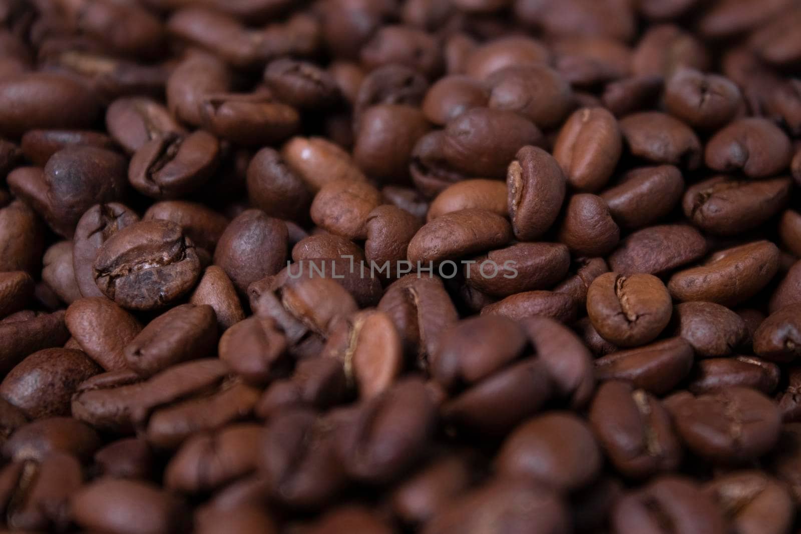 close up Freshly roasted coffee beans background. top view.