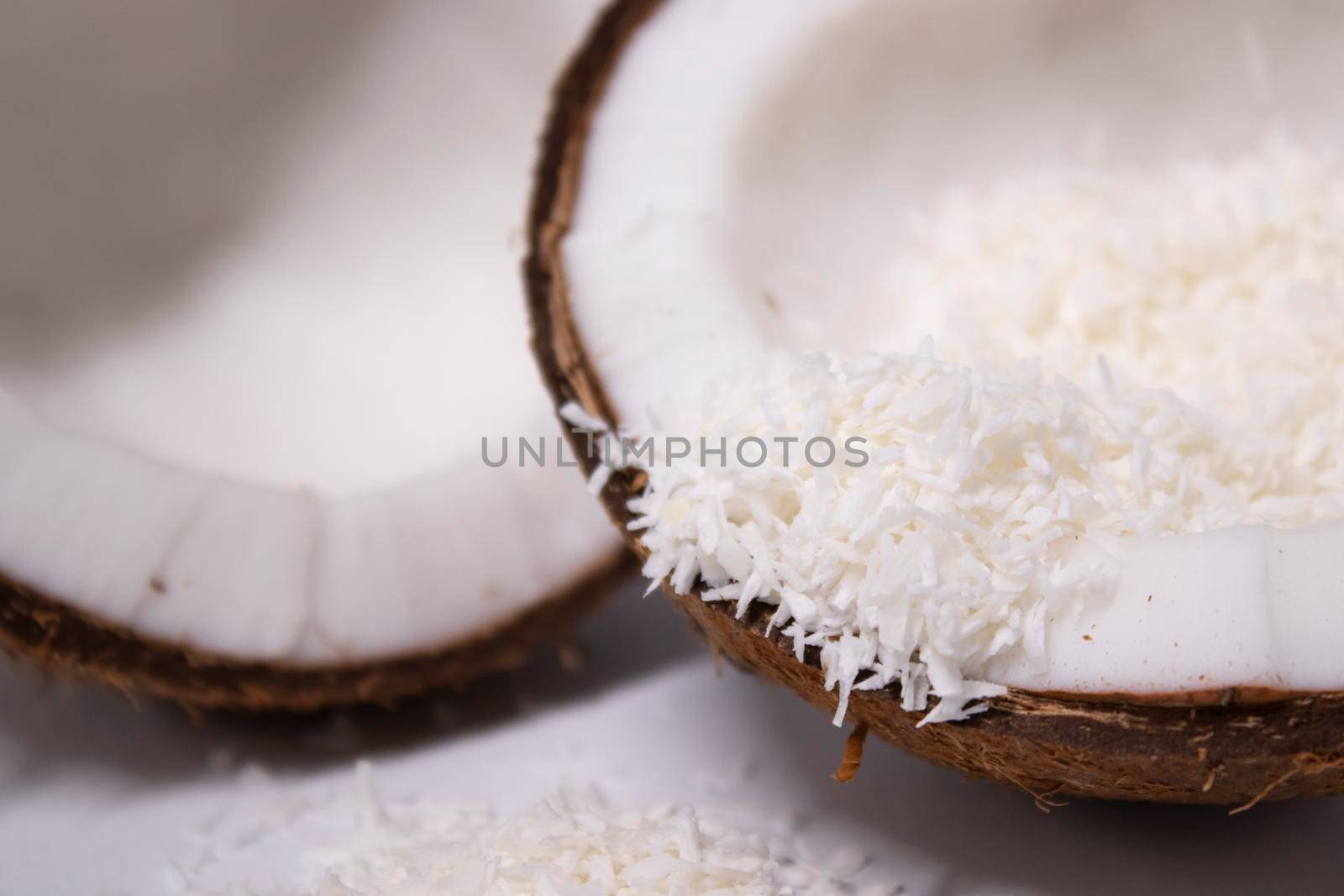 opened coconut with coconut flakes isolated on white background. tropical, nut.