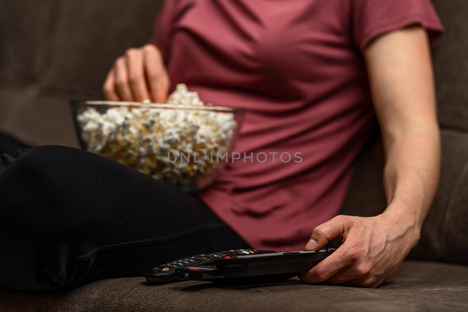 remote control and popcorn when watching a movie and broadcasting by Edophoto