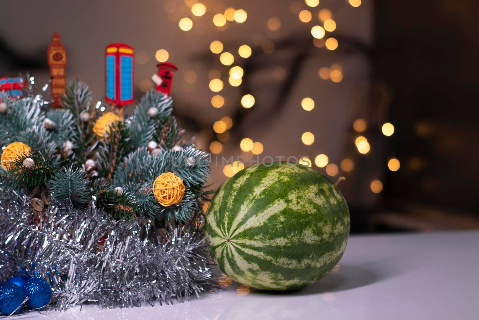 watermelon next to new year decorations. christmas theme.