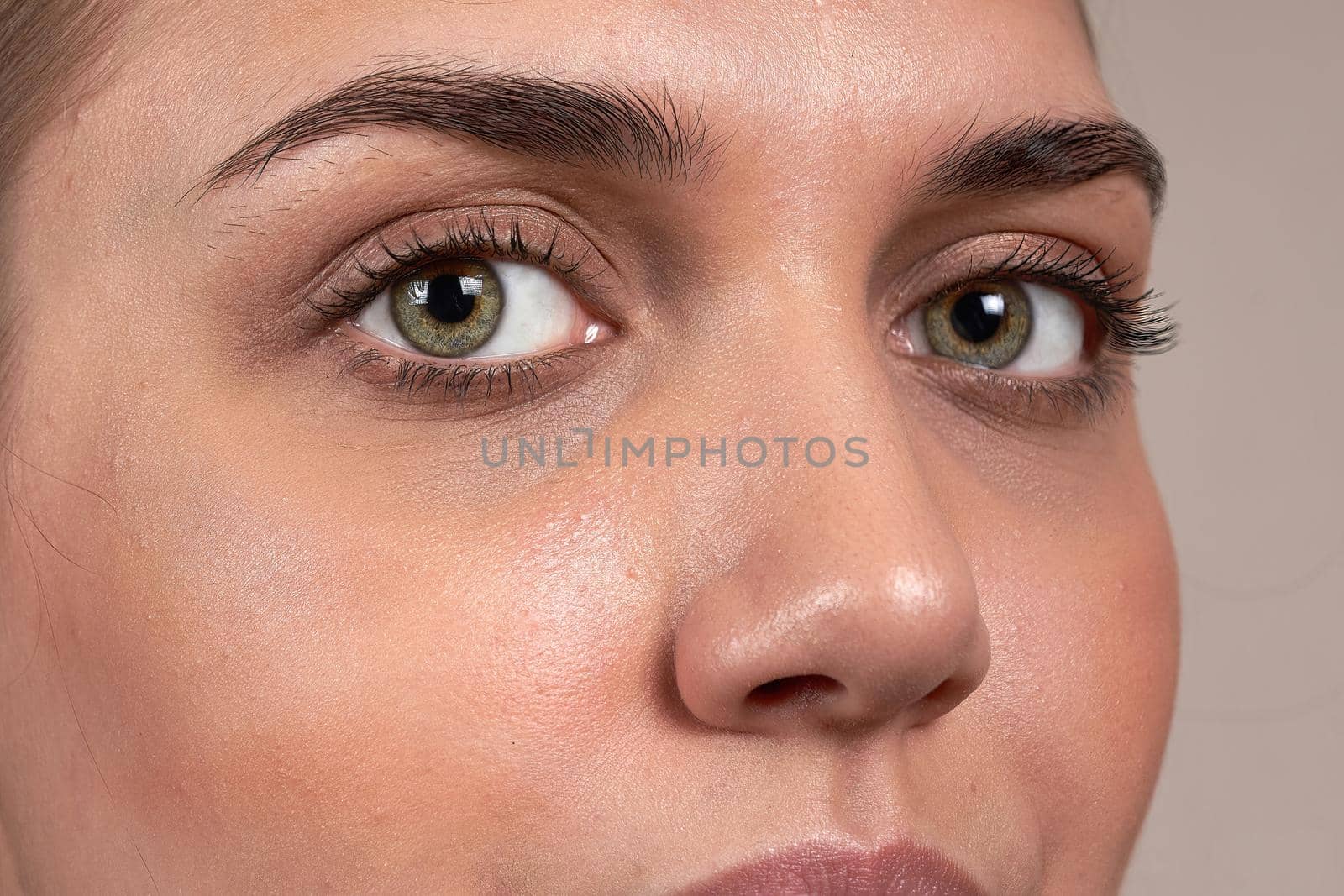 Close up of a beautiful female eye and a processed eyebrow, macro shot