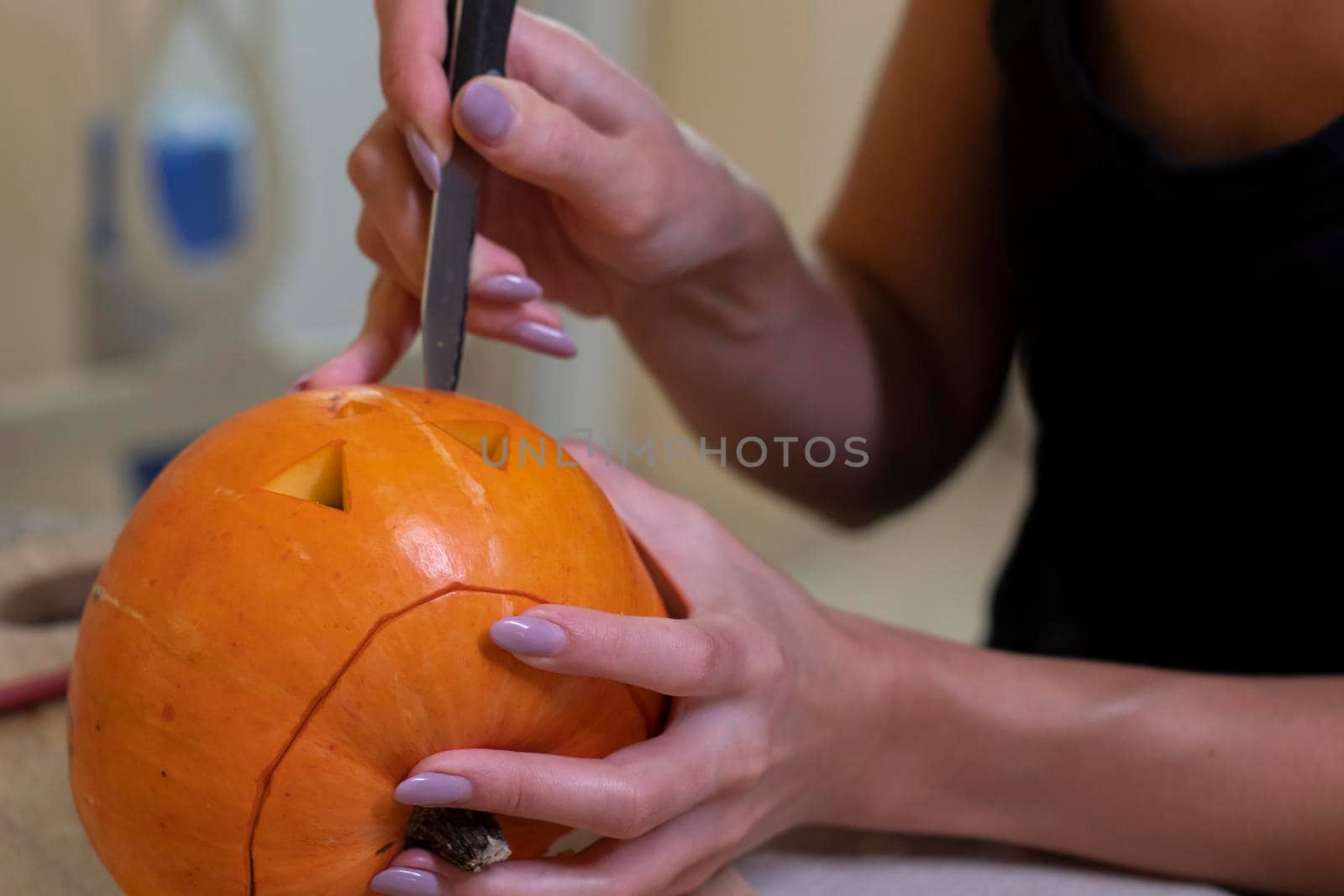 the process of making a Halloween pumpkin. cutting out the mouth. horror theme and Hallowe'en by oliavesna