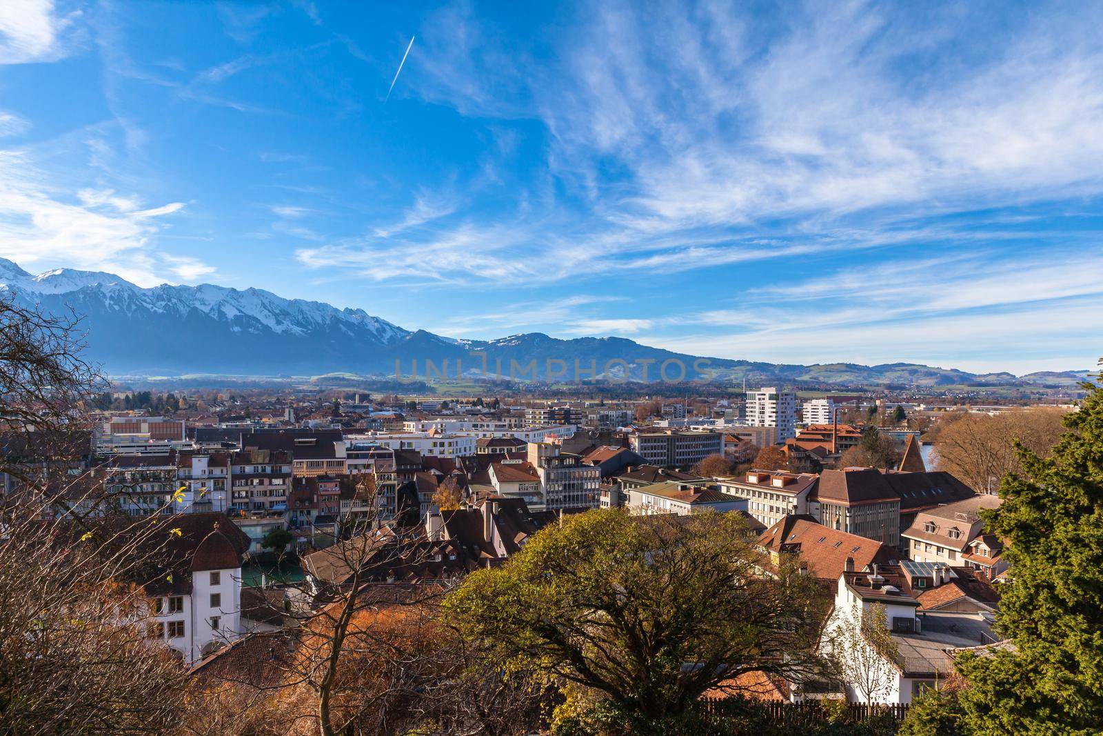 Aerial  view of the Thun city with the snow covered peaks of Alps in background, Canton of Bern, Switzerland