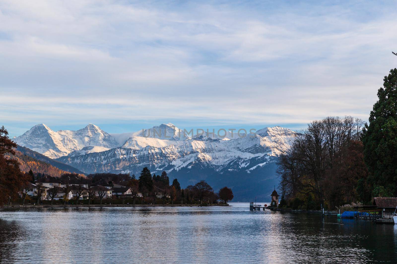 Panorama view of the lake Thun and Bernese Apls including Jungfrau, Monch and Eiger Northface from the lakeside of Thun, Canton of Bern, Switzerland.