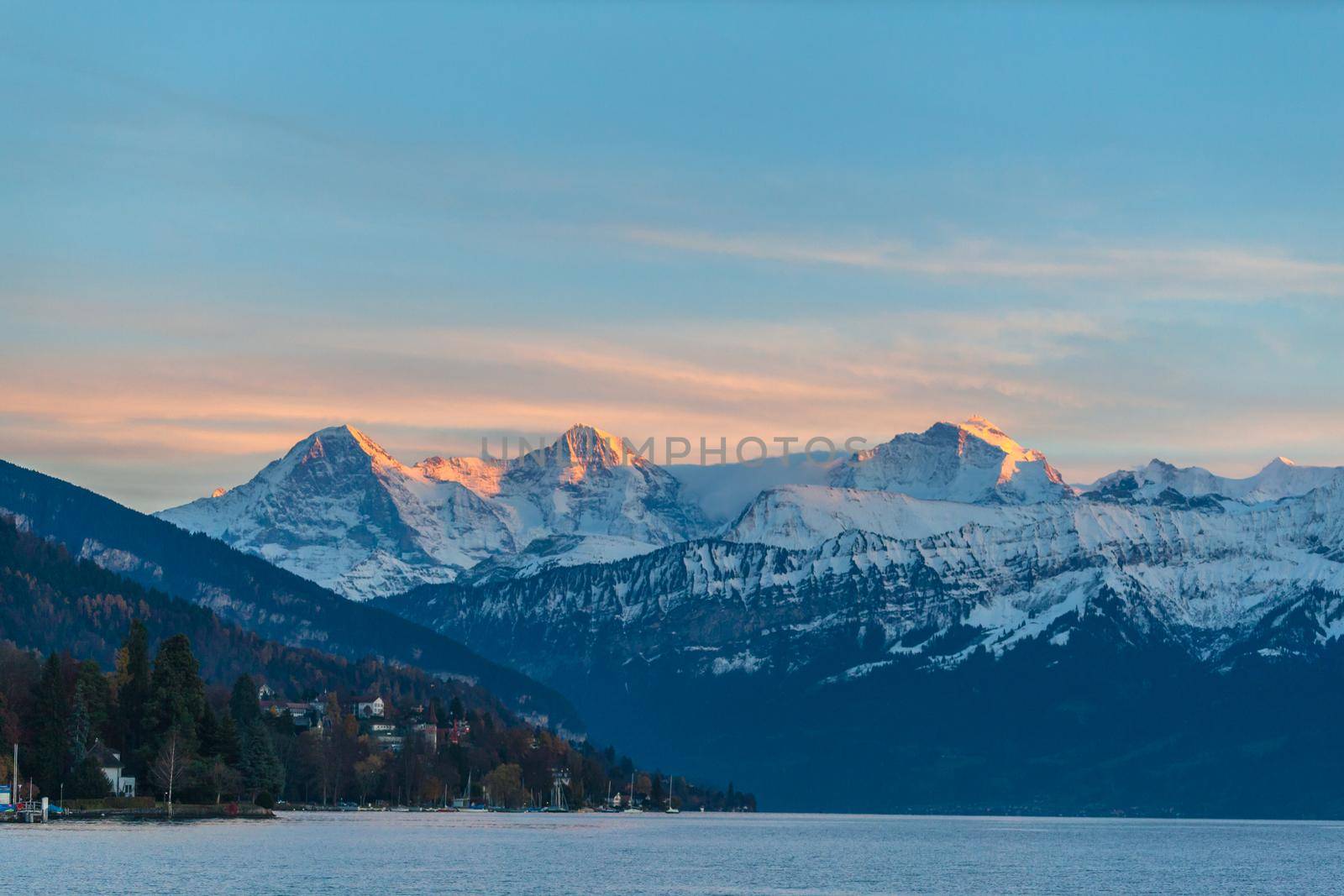Stuuning view of Eiger North Face and Monch, jungfrau in sunset from the lake side of the Thun lake, Canton of Bern, Switzerland