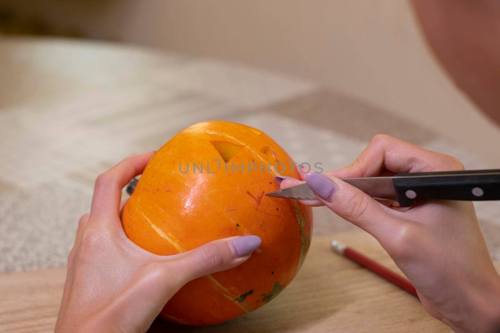 the process of making a Halloween pumpkin. cutting out the mouth. horror theme and Hallowe'en.